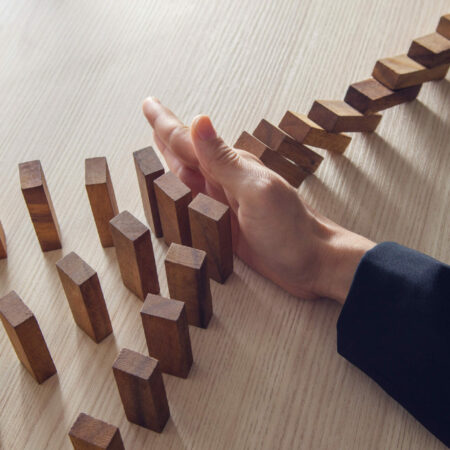 Businesswoman,Hand,Stopping,The,Domino,Wooden,Effect,Concept,For,Business.